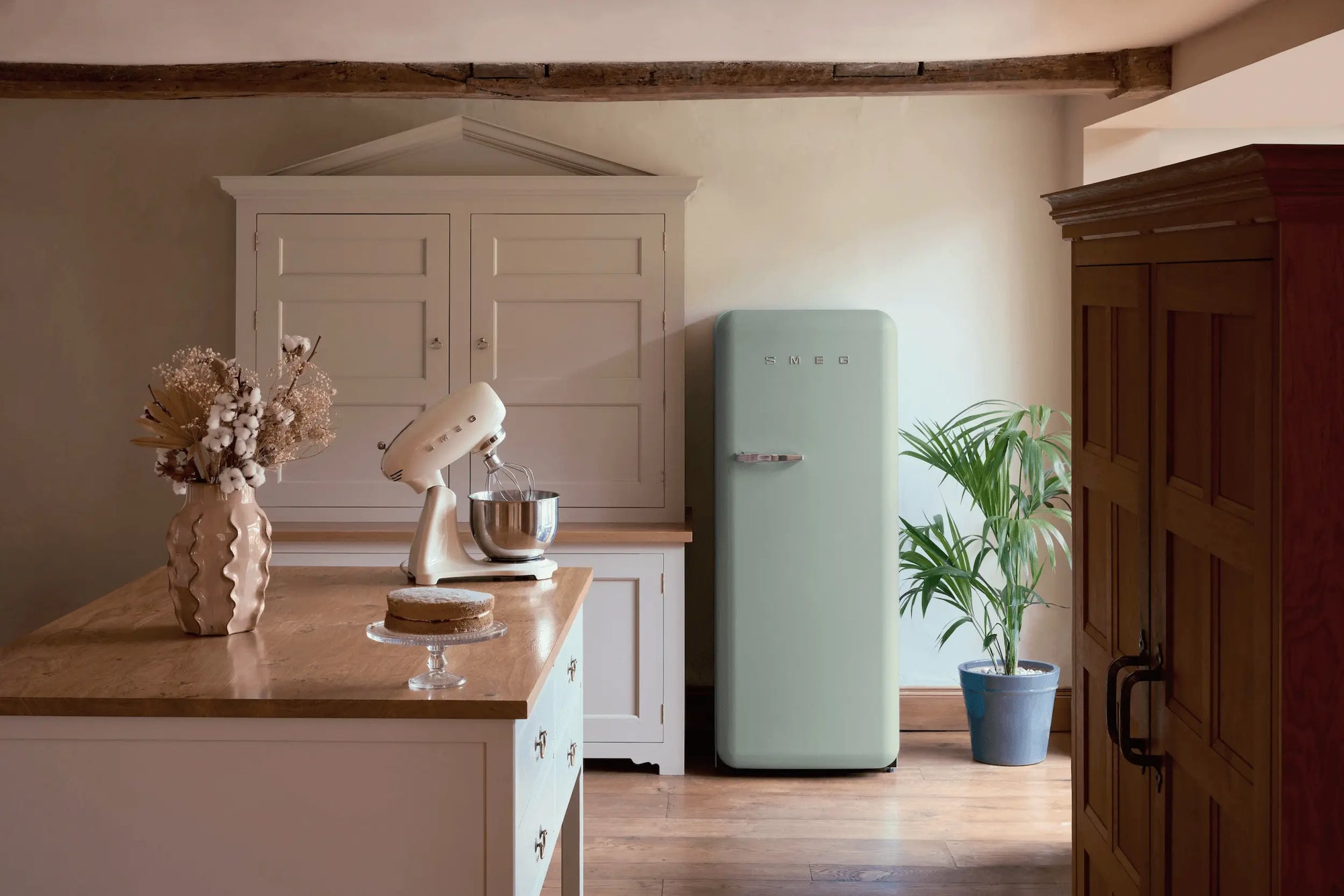 Retro-style kitchen with SMEG FAB refrigerator and pastel appliances
